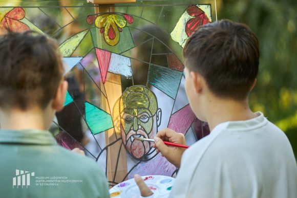 Na pierwszym planie uczniowie Publicznej Szkoły Podstawowej nr 2 im. Jana Pawła II w Szydłowcu podczas zajęć artystycznych „Witraż w plenerze”.